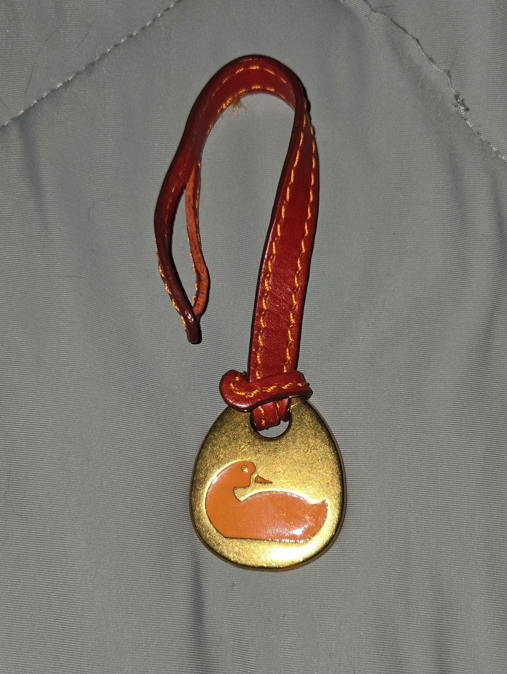 Dooney & Bourke Orange Duck Pendant with Red Leather Strap